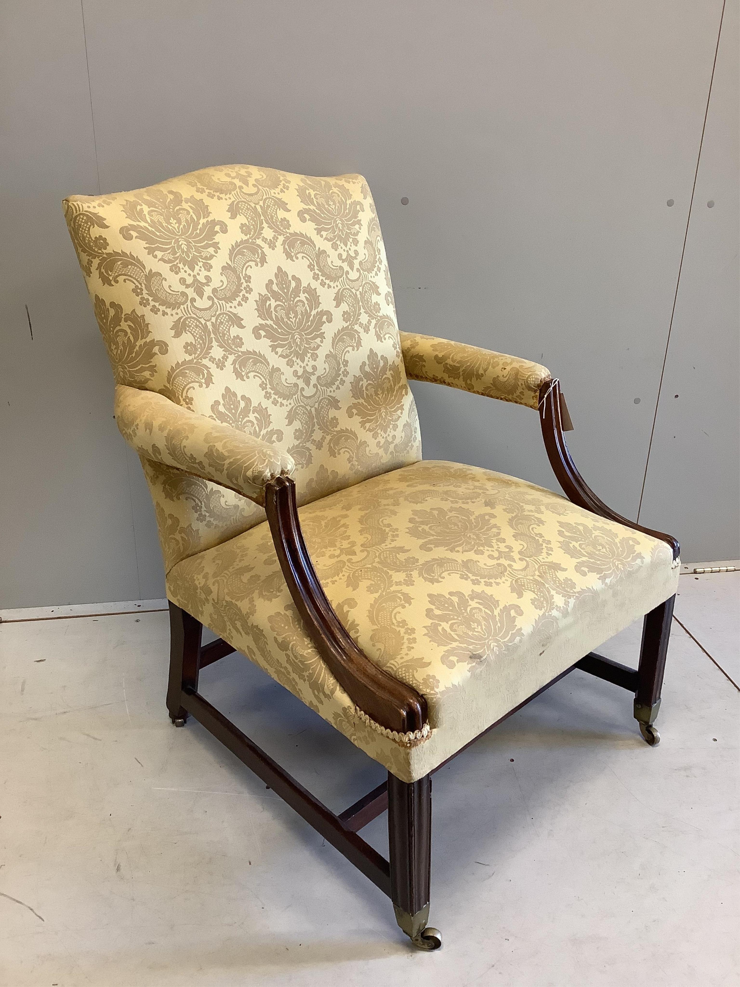 A George III mahogany Gainsborough style chair, width 72cm, depth 67cm, height 93cm. Condition - fair, old repair to both arms and front right leg, stretcher appears a later replacement.